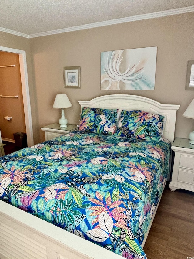 bedroom featuring crown molding and wood finished floors