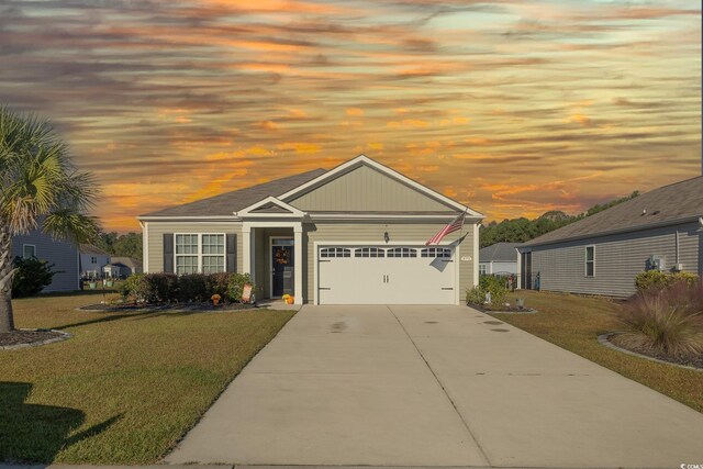 view of front of house with a garage and a lawn