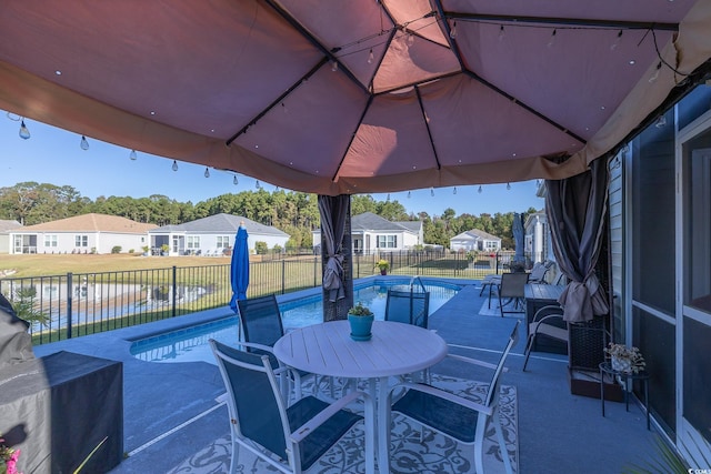 view of patio / terrace featuring a water view and a fenced in pool