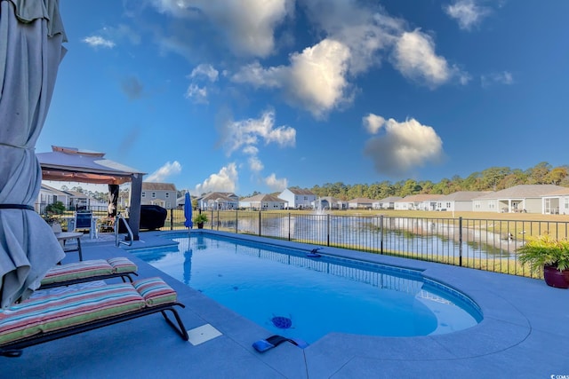 view of swimming pool featuring a patio area and a water view