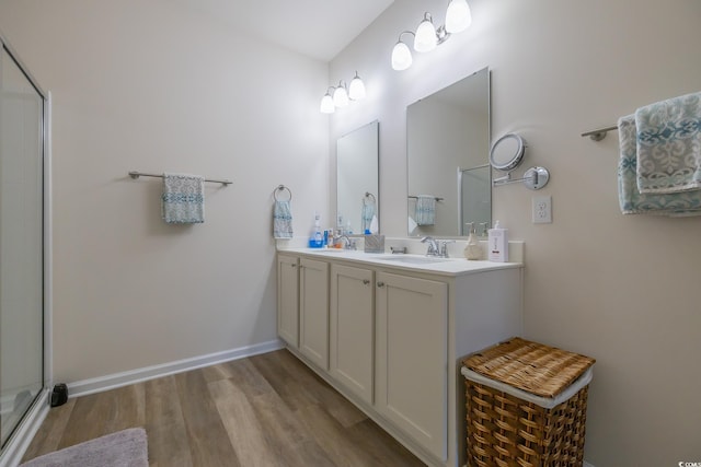 bathroom with vanity, wood-type flooring, and an enclosed shower