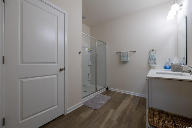 bathroom with vanity, walk in shower, and hardwood / wood-style flooring