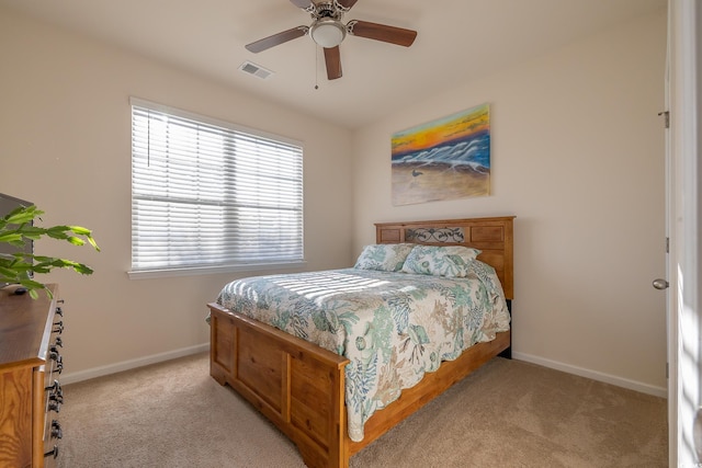 bedroom with ceiling fan and light colored carpet