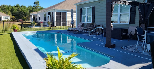 view of swimming pool with a patio area and a lawn