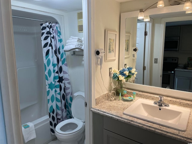 full bathroom with vanity, shower / bath combo with shower curtain, and toilet