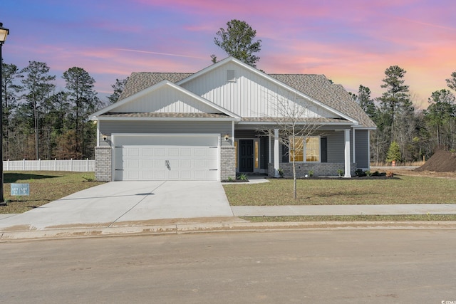 view of front of house featuring a lawn and a garage