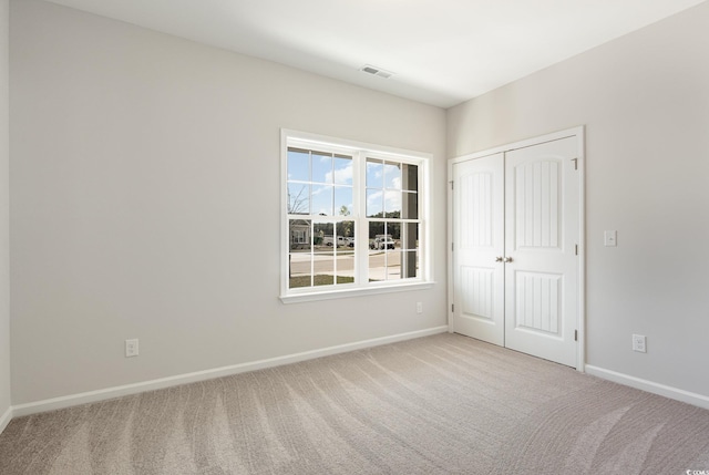 empty room featuring light colored carpet