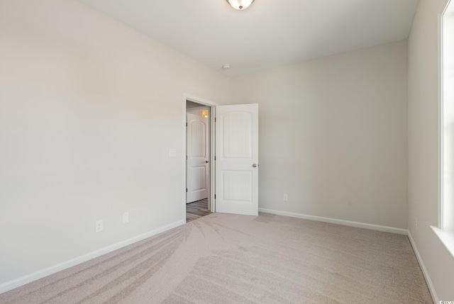 spare room with light colored carpet