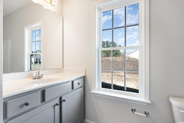 bathroom featuring toilet and vanity