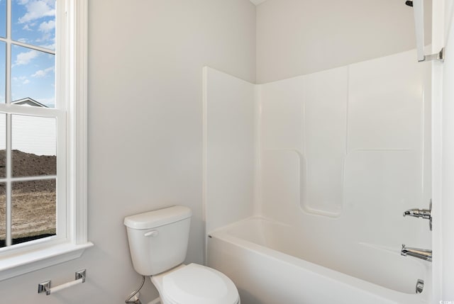 bathroom with toilet and shower / tub combination