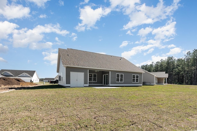 back of house with a patio area and a yard