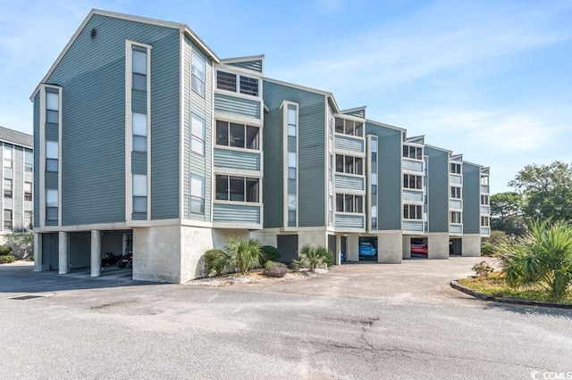 view of property featuring uncovered parking