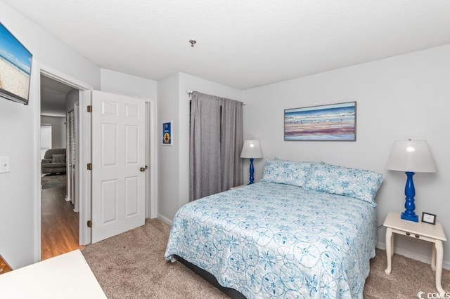 carpeted bedroom with baseboards