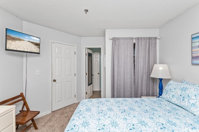 bedroom with baseboards and carpet