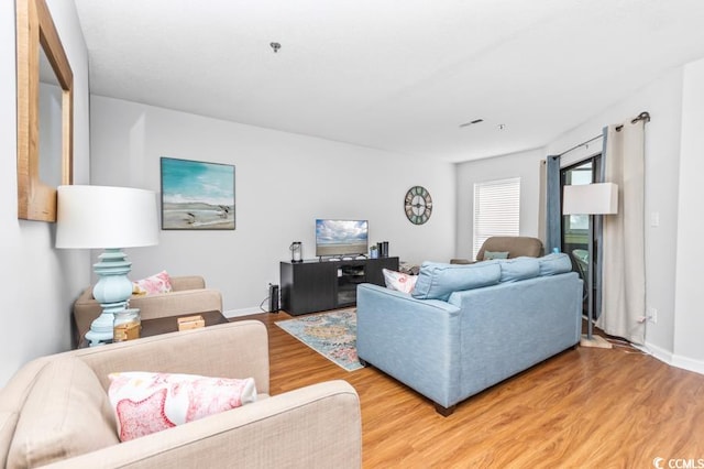 living room with baseboards and wood finished floors