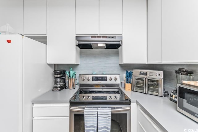 kitchen featuring exhaust hood, white cabinets, stainless steel appliances, and tasteful backsplash