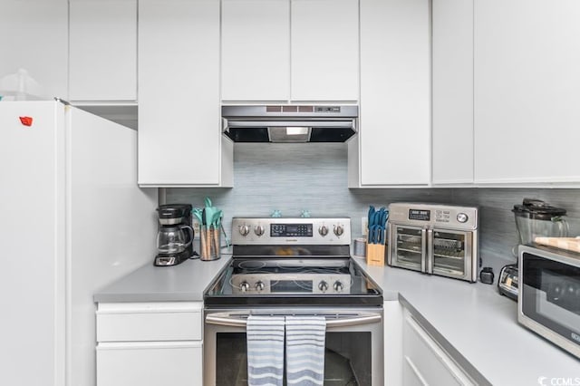 kitchen featuring under cabinet range hood, stainless steel appliances, white cabinets, and light countertops