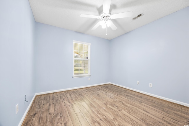 spare room with light hardwood / wood-style flooring, a textured ceiling, and ceiling fan