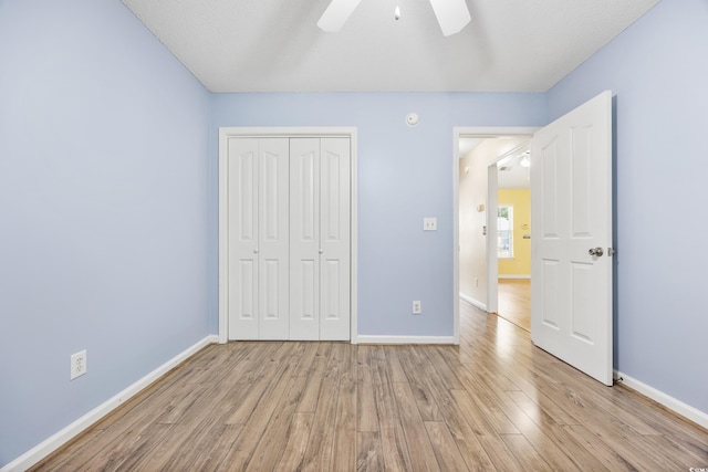 unfurnished bedroom with a closet, ceiling fan, a textured ceiling, and light wood-type flooring