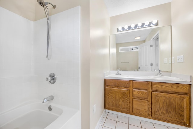 bathroom featuring vanity, bathtub / shower combination, tile patterned floors, and a textured ceiling