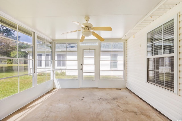 unfurnished sunroom featuring ceiling fan