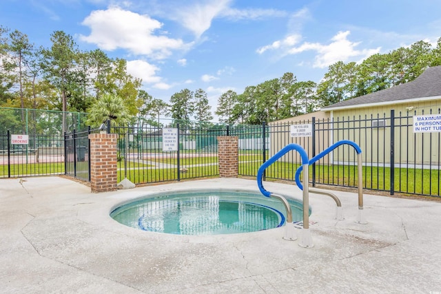 view of pool with a community hot tub and a yard