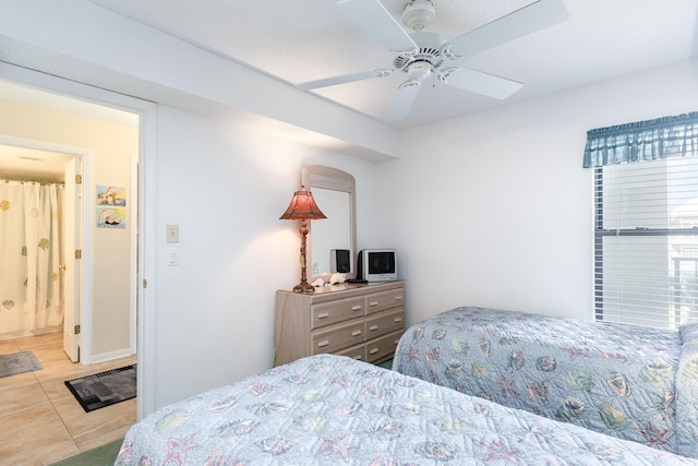 bedroom with ceiling fan and light tile patterned floors