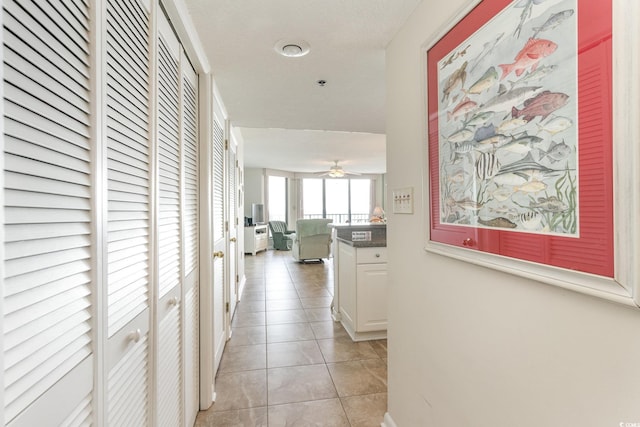 hall featuring light tile patterned floors