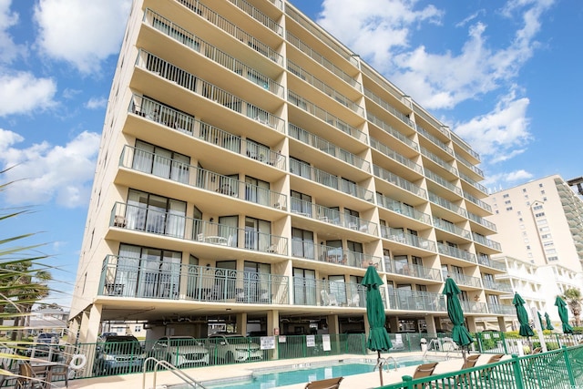 view of building exterior featuring a community pool