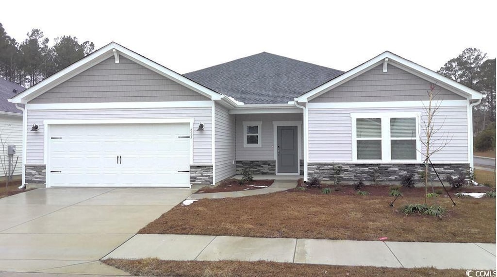 craftsman-style house with a front lawn and a garage