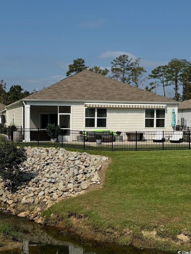 back of house featuring a lawn