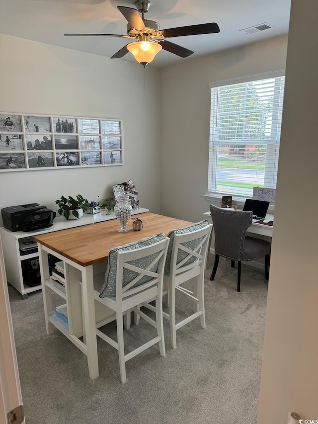 dining area featuring carpet flooring and ceiling fan