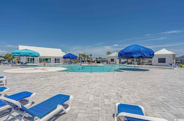 view of swimming pool with a patio