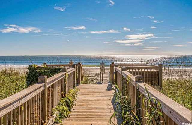 view of home's community featuring a water view and a view of the beach