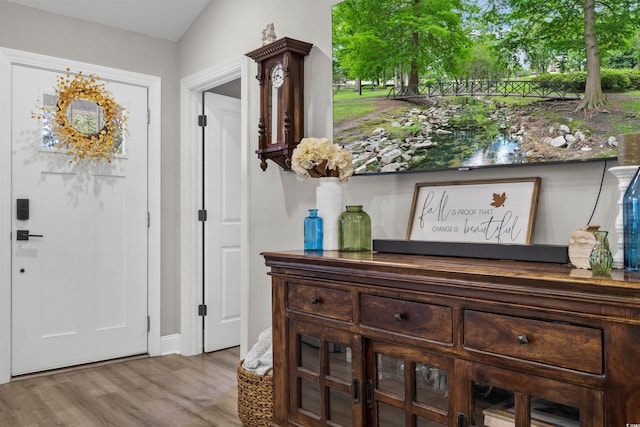 foyer featuring light hardwood / wood-style floors and lofted ceiling