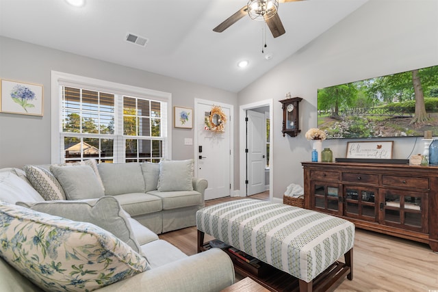 living room featuring light hardwood / wood-style flooring, ceiling fan, and lofted ceiling