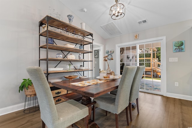 dining room with dark hardwood / wood-style flooring, lofted ceiling, and an inviting chandelier