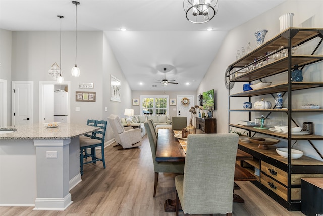 dining space with dark hardwood / wood-style flooring, ceiling fan, and lofted ceiling