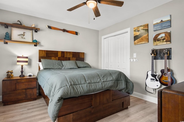 bedroom featuring light hardwood / wood-style floors, a closet, and ceiling fan