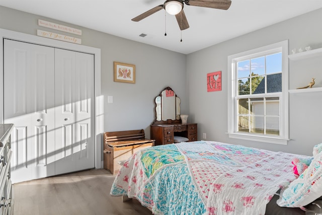 bedroom with ceiling fan, light hardwood / wood-style floors, and a closet