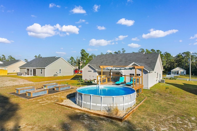 view of swimming pool with a pergola, a yard, and a wooden deck