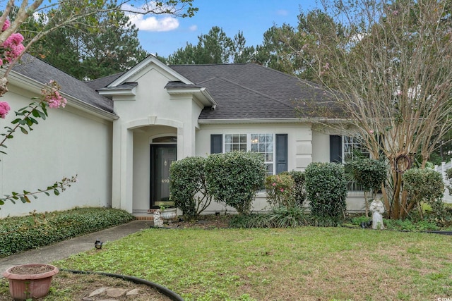 490 Blackberry Ln, Myrtle Beach, SC 29579 - ranch-style home featuring roof with shingles, a front yard, and stucco siding