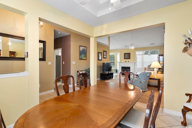 tiled dining space with ceiling fan