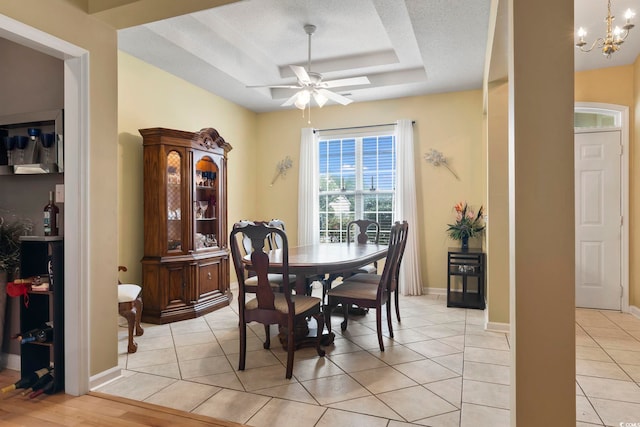 dining area featuring a textured ceiling, ceiling fan with notable chandelier, and light wood-type flooring