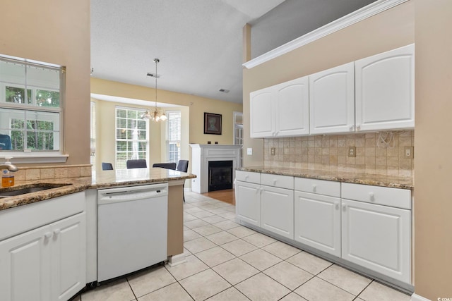 kitchen with light tile patterned flooring, hanging light fixtures, dishwasher, and white cabinets