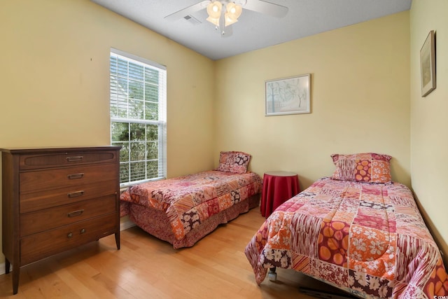 bedroom featuring light hardwood / wood-style floors and ceiling fan