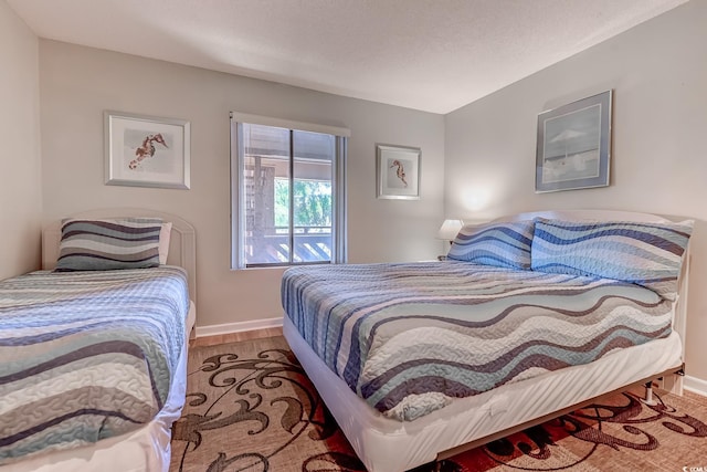 bedroom with light hardwood / wood-style flooring and a textured ceiling