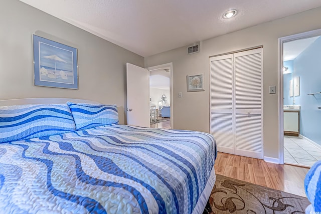 bedroom featuring light hardwood / wood-style floors and a closet