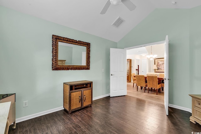 interior space featuring hardwood / wood-style flooring, vaulted ceiling, and ceiling fan with notable chandelier