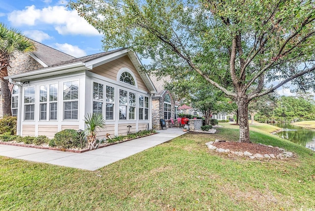 exterior space featuring a water view and a lawn